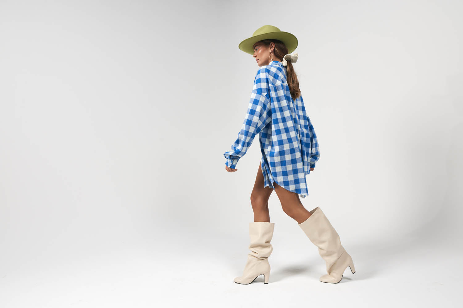 Model wearing blue and gingham printed oversized shirt dress
