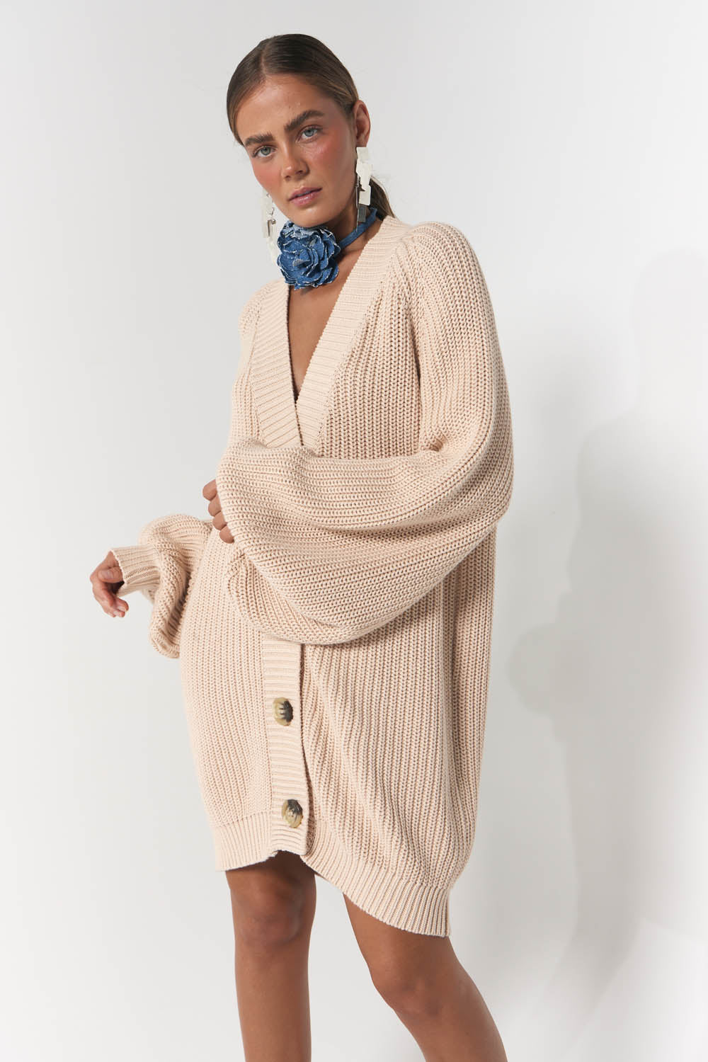 Model wearing oversized knit cardigan in stone neutral colour 