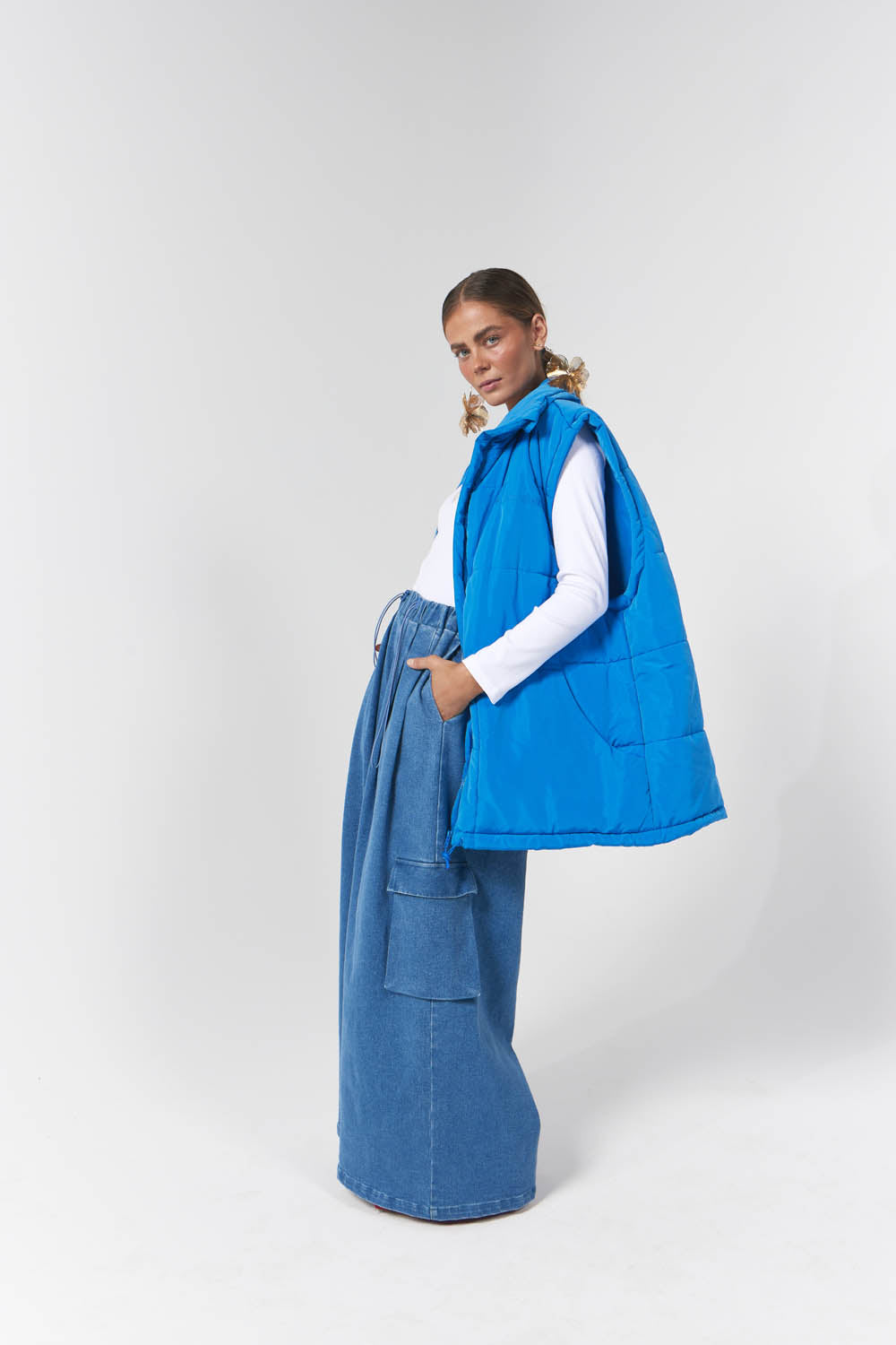 Model wearing blue puffer vest perfect for winter fashion