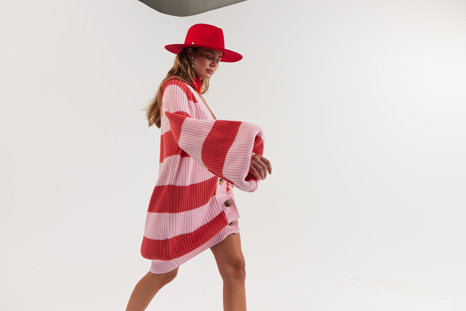 Woman wearing a red and white striped sweater and hat