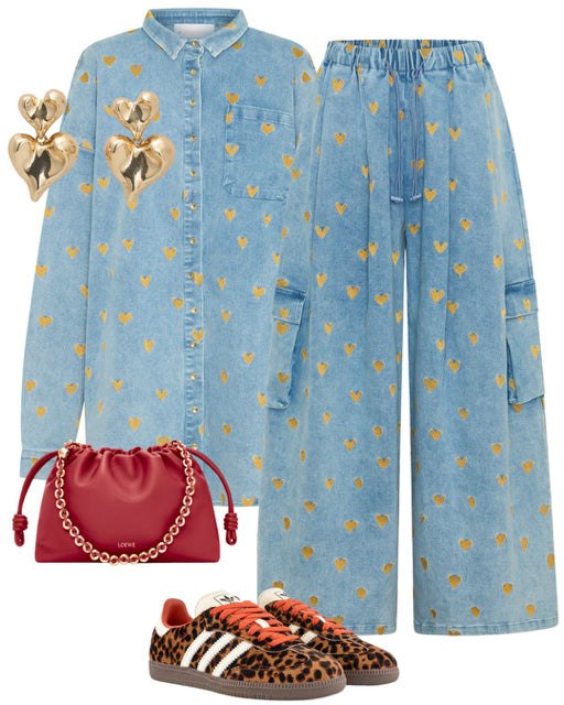 Denim outfit with gold heart patterns, red purse, and leopard print shoes on a white background