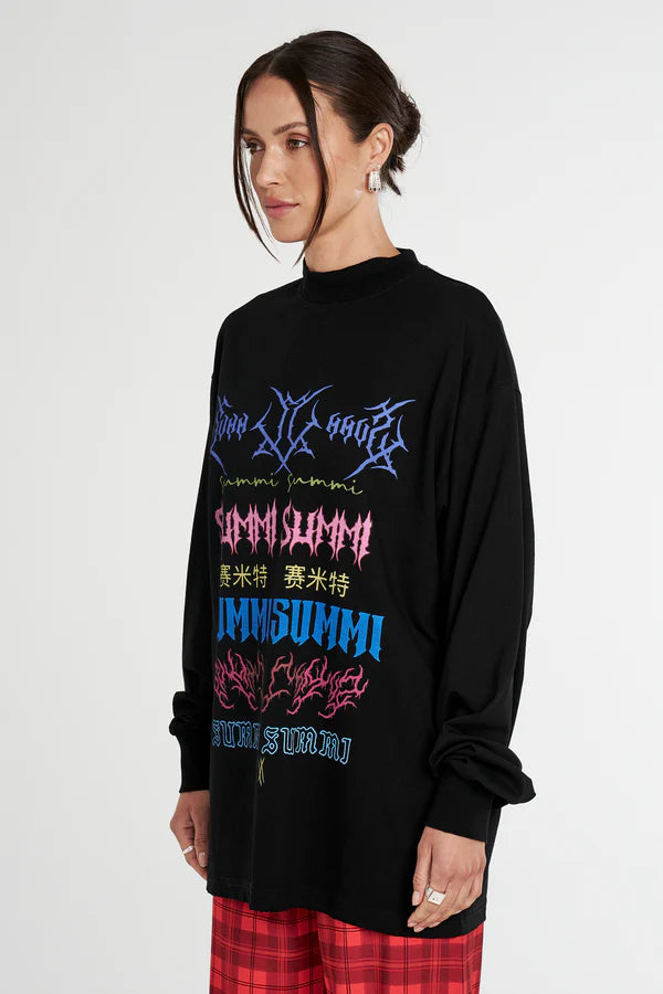 Person wearing a black long-sleeve  Summi Summi shirt with colourful text and graphics on a white background