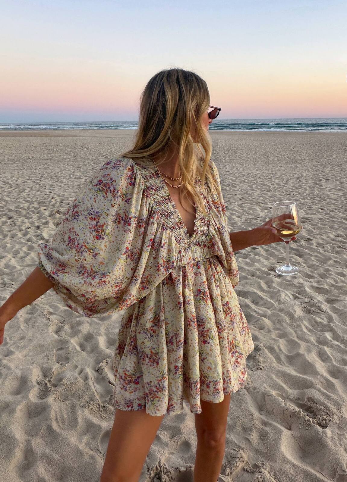 La Bohème Girls Essie V Neck Mini Dress in Confetti Bloom – worn on the beach at sunset