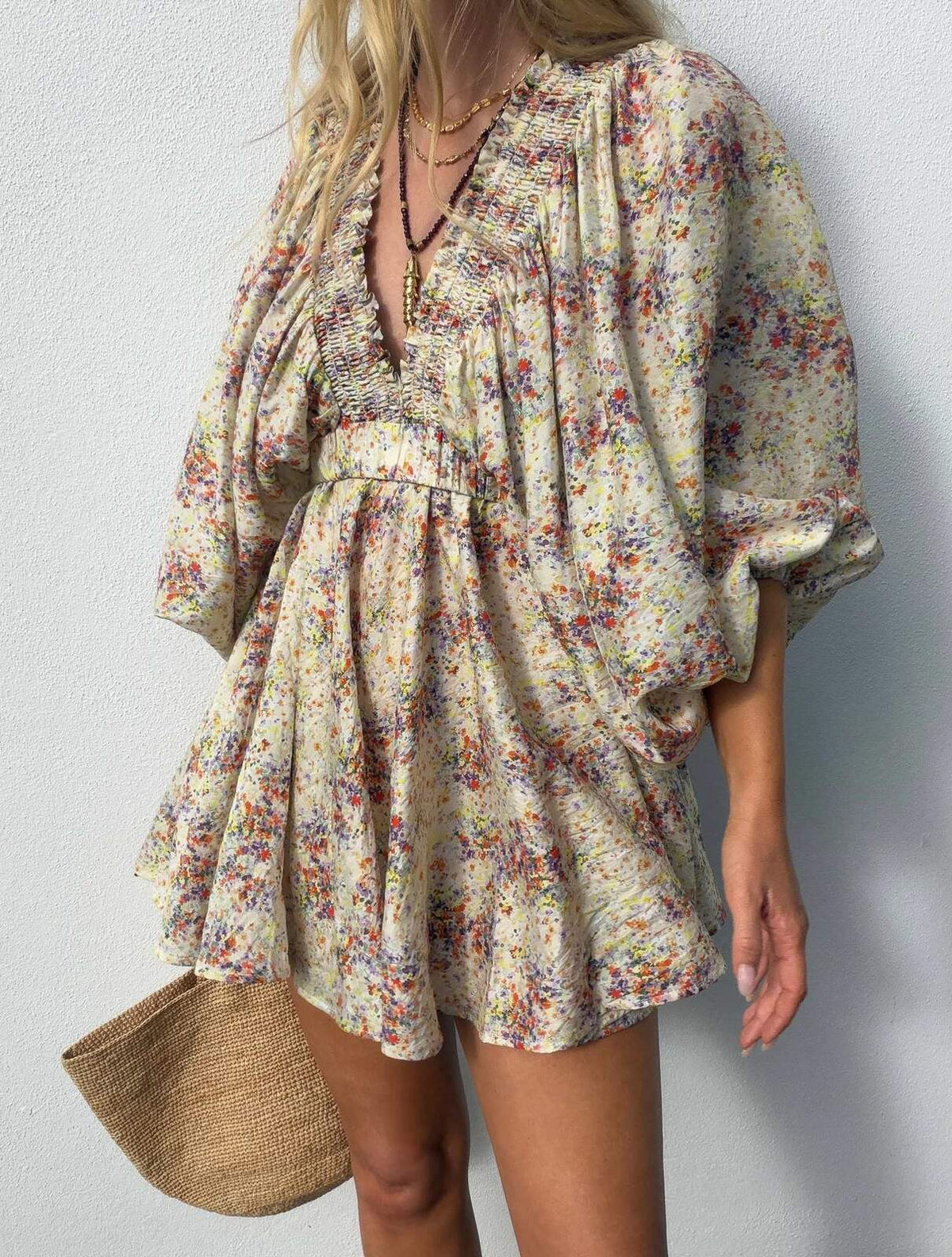 La Bohème Girls Essie V Neck Mini Dress in Confetti Bloom – close-up of the floral print with a straw bag