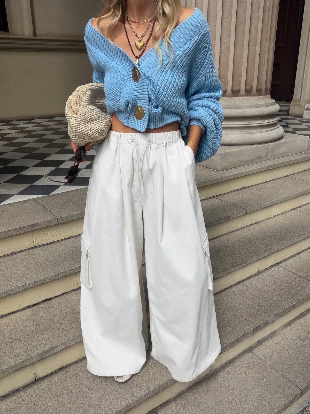 La Bohème Girls Cropped Elsie Cardigan in Blue Tourmaline – styled with white cargo pants on sandstone steps