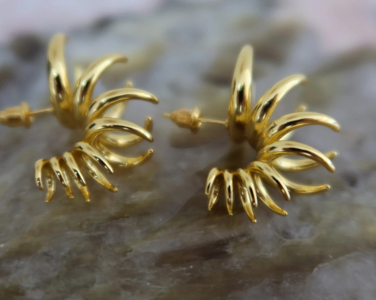 La Bohème Girls Molten Earrings in Gold – gold sculptural drop earrings on stone