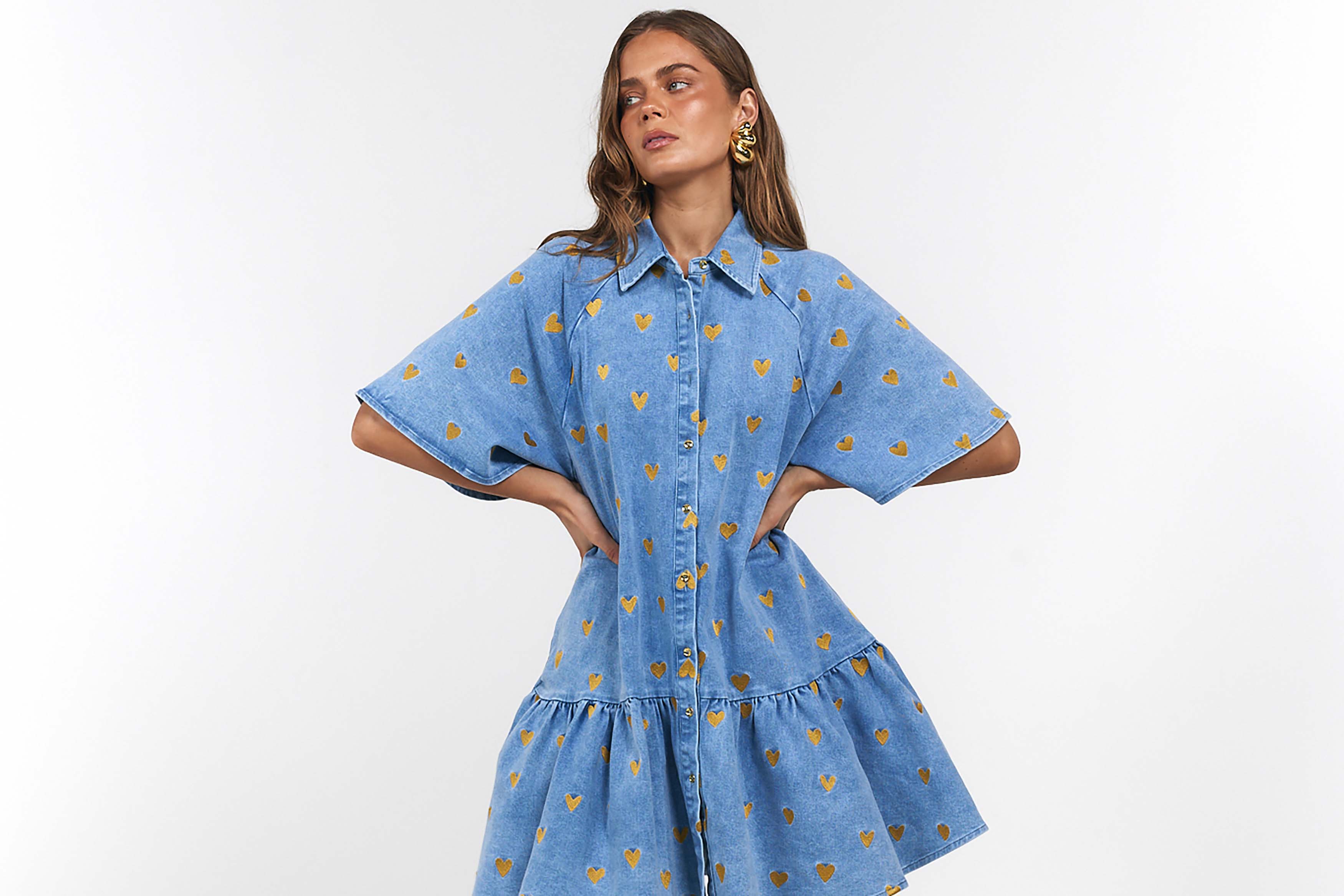 Woman wearing a blue dress with gold hearts